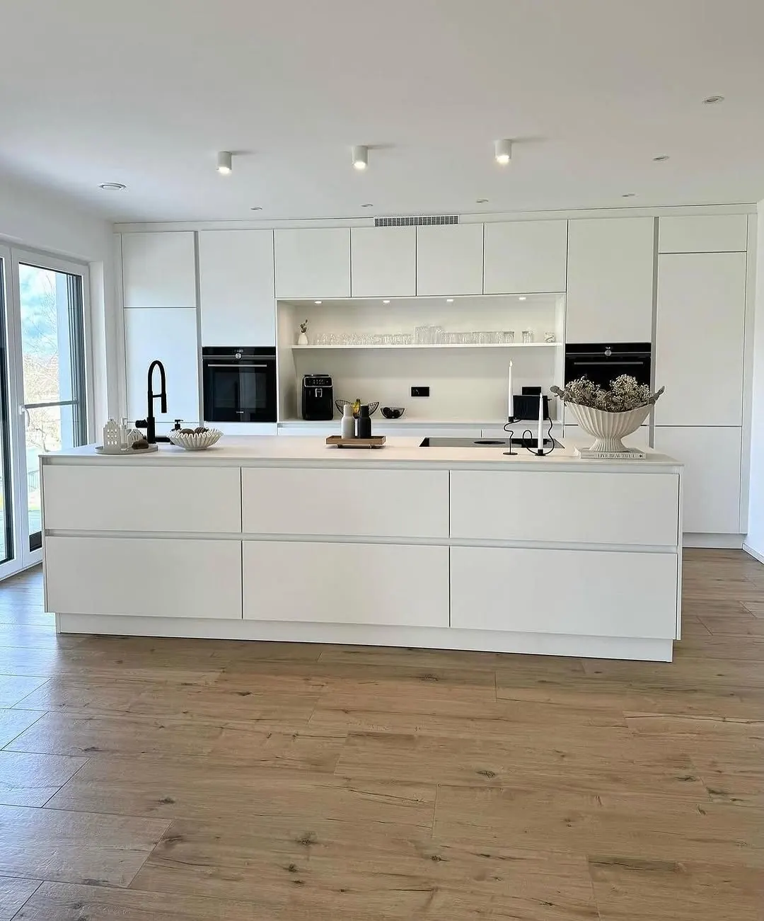 White kitchen with oak floor
