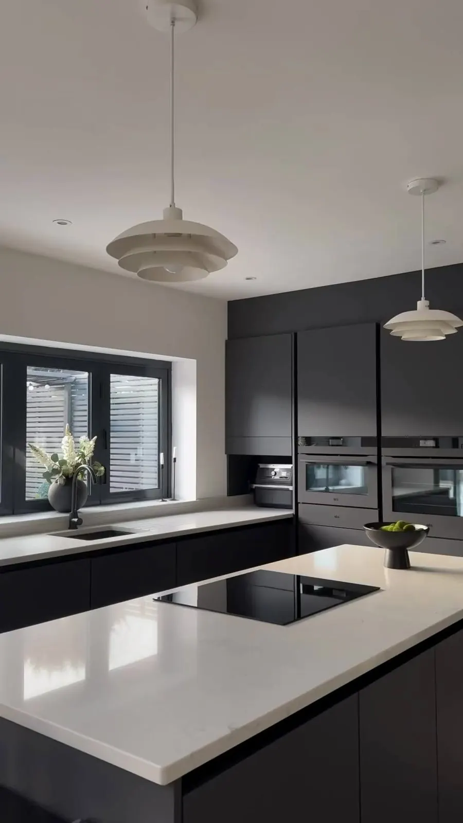 Black kitchen with white worktop